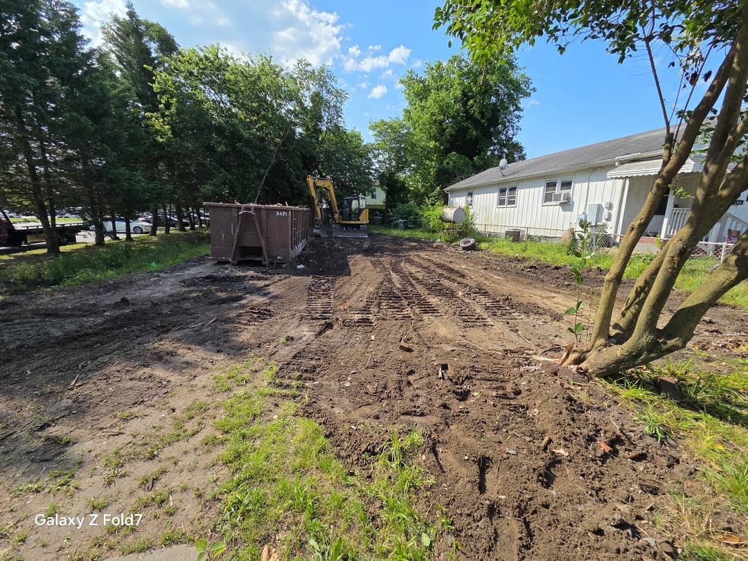 Construction site with heavy machinery and cleared ground for building.
