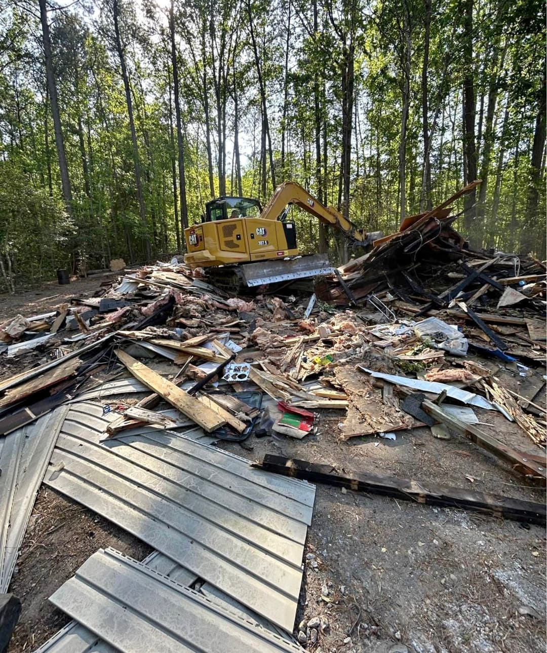 Demolishing a burnt garage.